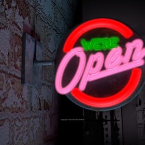 We Are Open Video - a dark street with a neon sign that says "We're open"