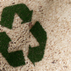 Reduce Reuse Recycle Graphics. Blades of grass grow out of the ground and form the familiar recycle symbol.