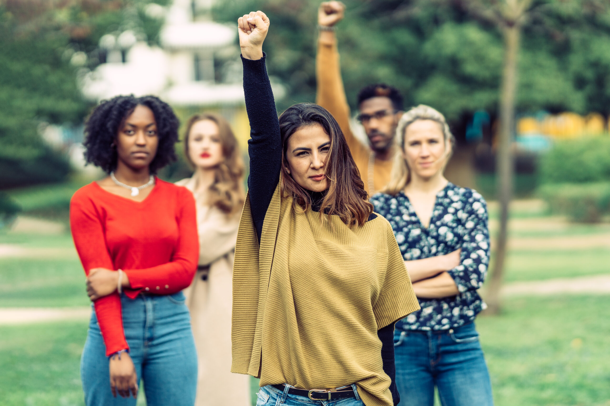 Latina woman raises her fist at a protest