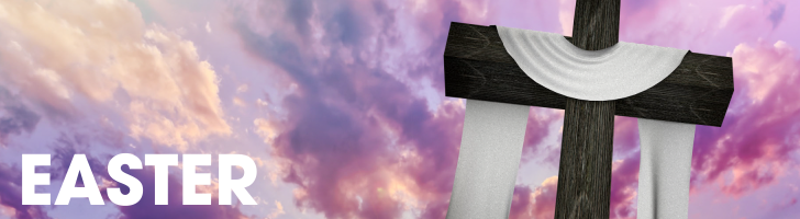 A cross draped in a white cloth against a sunrise sky