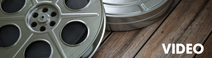 Image features reels of movie film.