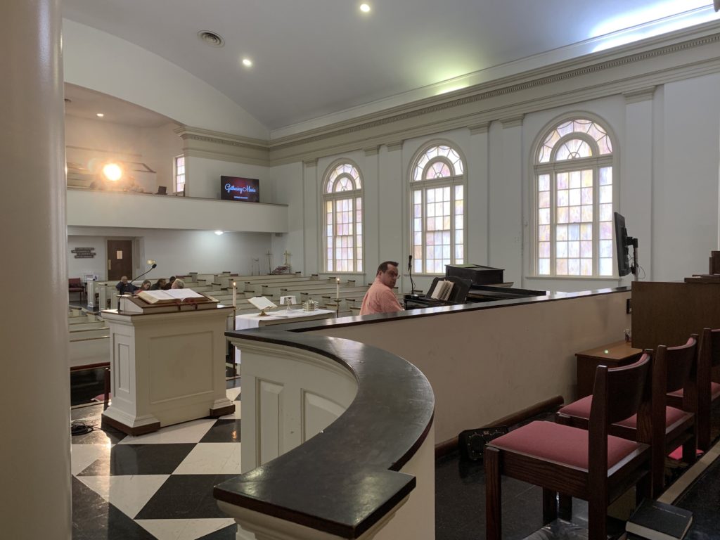 Image features the sanctuary of a church from the pulpit's view