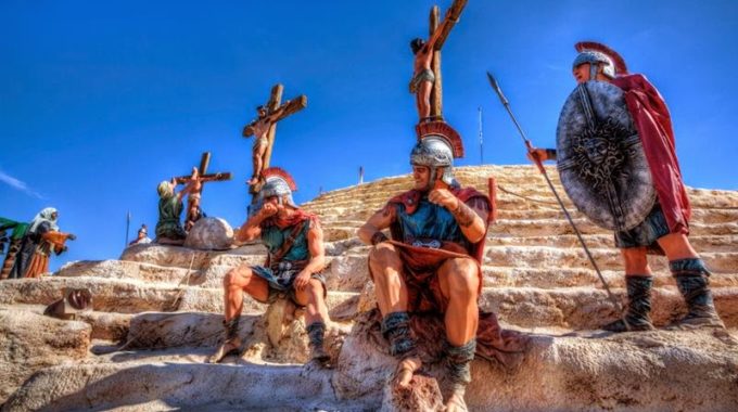Roman soldiers sit under the cross.