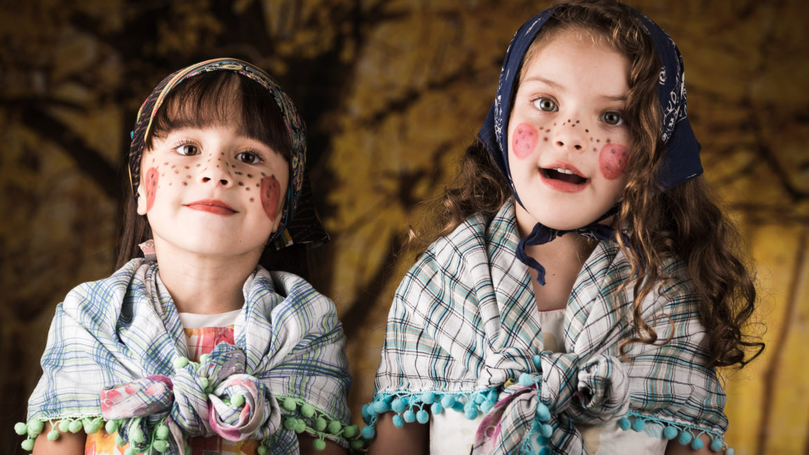 Two young girls with painted faces for Easter in Sweden.