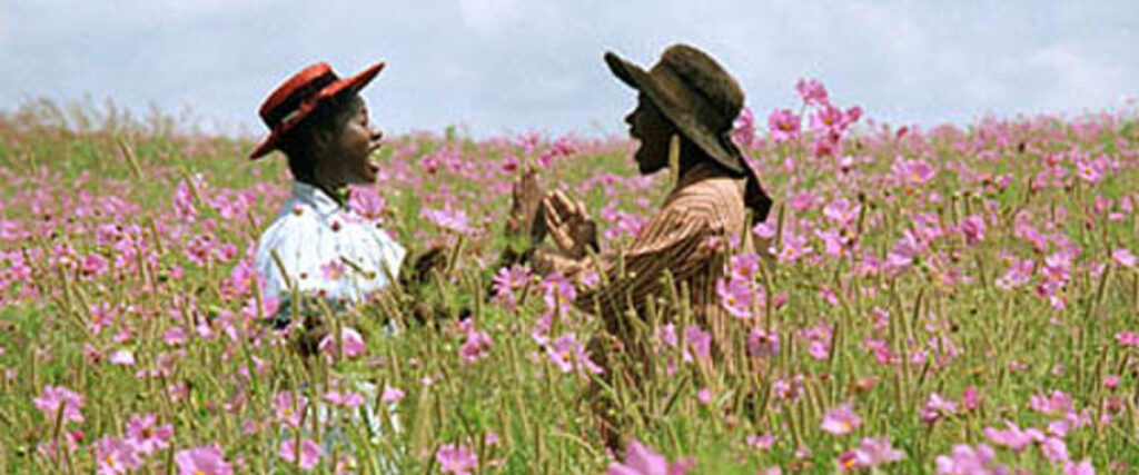 Two black girls playing in a field together (scene from "The Color Purple")