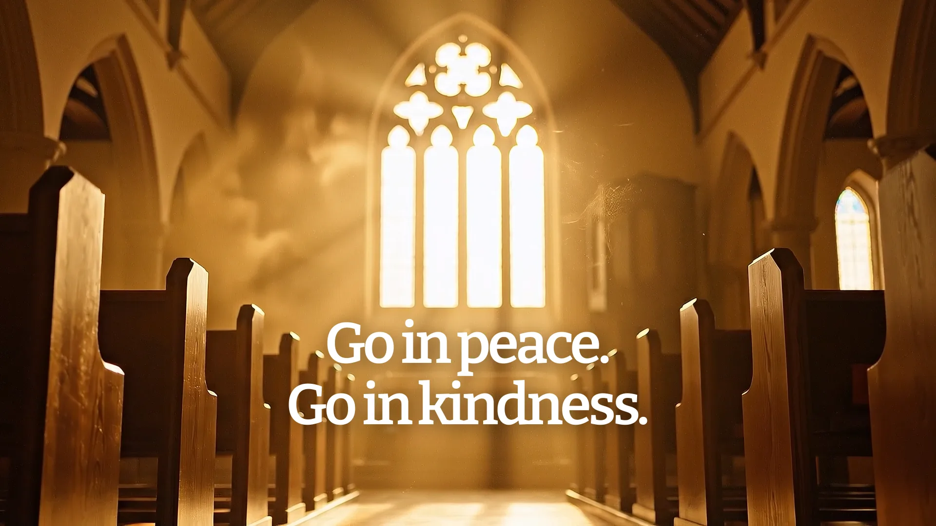 Church sanctuary interior with Gothic window and wooden pews displaying "Go in peace. Go in kindness" benediction text