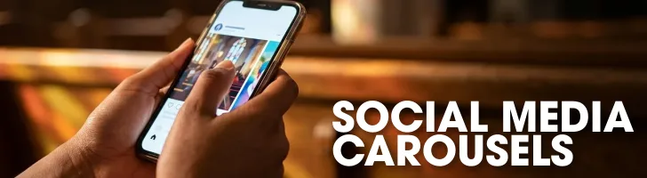 Person holding smartphone displaying social media carousel content with warm interior lighting